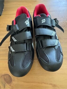 Peloton black cycling shoes with white swoosh-like logo